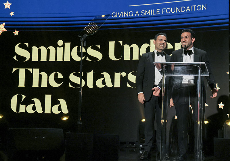 Dr. Rodney Raanan DDS, MMSC and Dr. Justin Raanan on stage - Giving A Smile Gala 2025